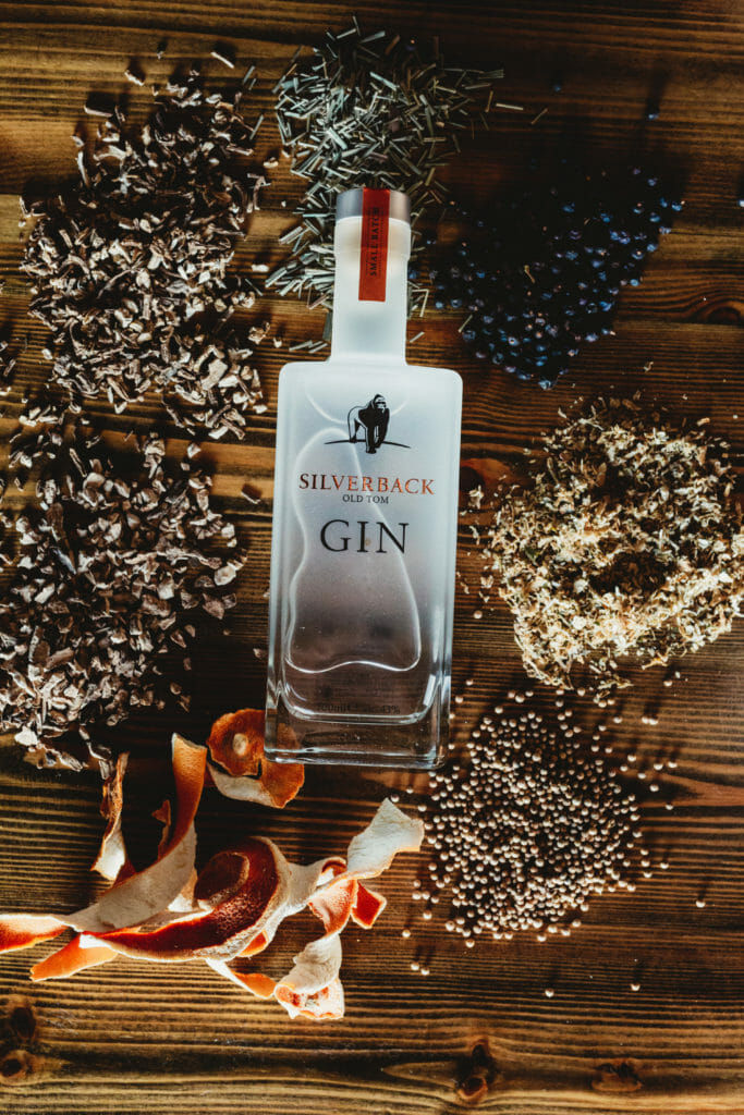 Silverback Old Tom Gin surrounded by botanicals such as coriander, juniper berries, orange peel, and angelica root used to craft the spirit - Gorilla Spirits Co.