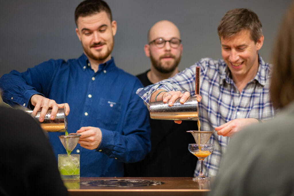 Guests pouring cocktails during cocktail masterclass